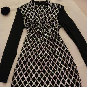 Mini dress new in black and silver. With sequins, and sheer sleeves and back